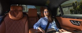 Business woman sitting in luxury car interior