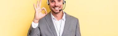young handsome man feeling happy, showing approval with okay gesture. telemarketer concetp